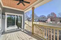 Gorgeous tongue and groove ceiling on covered back porch overlooking generous, fenced-in back yard