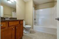 Third full bathroom with tile floors and granite countertops on 2nd level