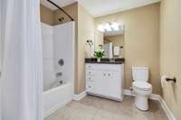 Second full bathroom on the main level with tile floors and granite countertops