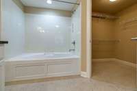 Primary bathroom: Garden tub with shower and the walk in closet.