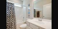 Stock photo of secondary bathroom with natural light privacy window