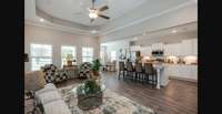 Stock photo showing great room from entrance. Notice open concept and large island. Lots of windows!