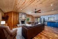 10’ Wood Ceiling w/ Wood Burning Fireplace!! Great room is open to living, kitchen & dining w/ doors out to front porch & wrap around decks!!