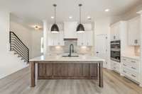 Kitchen features quartz counters, custom white soft close cabinets, under cabinet lighting