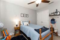 Bedroom 4 with a ceiling fan, closet and carpeted floor.