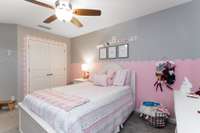 Bedroom 2 on second level has a beautiful painted wall and trim around the doorways, a ceiling fan and a nice size closet.