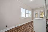 The spacious utility room is a great space with tons of natural light and an exterior door leading out to the side covered deck. Washer & dryer convey!