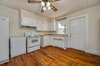 Hardwoods, window over the sink, exterior door leading out to the side covered deck and the refrigerator conveys!