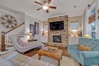 View of living area showing the staircase to 2nd level. Coat closet in the entry foyer across from the staircase.