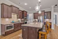 Recessed lighting.  Microwave under the counter for space saving.  LG French door refrigerator.  Cabinets on either side of the fridge are ideal for a coffee bar and charging station setups.