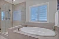 Soaking tub with tile surround.