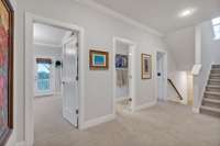 2nd Floor landing shows the entrances to bedrooms 3 & 4 along with the shared bath. Laundry room is located to the left of this picture.  Large linen closet is also outside the primary bedroom.