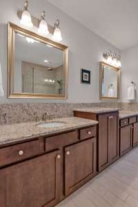 Double vanities have raised vanity in middle.  Soft close drawers and doors. Granite countertops.