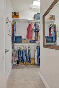 The 2nd closet in the primary suite. Double and single hanging options.