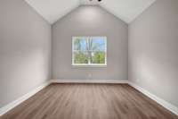 The large Primary bedroom features a vaulted ceiling.