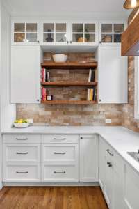 Soft close upper cabinets and drawers, 10x3 stone look tile backsplash and wood accent shelving provide beauty and functionality.