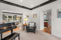 A beautiful, wide cased opening leads to the formal living or music room.