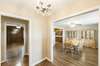 Entry Foyer with Chandelier opens to Living Room/Dining Room.