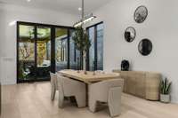 Large dining area with bold pendant. Open the sliding glass doors to bring the outside in.
