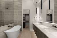 Glorious Primary Bathroom with floating double vanity, back-lit mirror, and large soaking tub