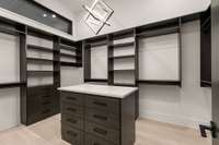 Oversized His and Hers closets with moveable shelving to tailor to your wardrobe needs.