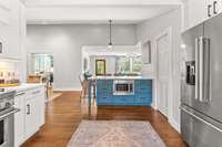 Gaze from the kitchen sink towards the front door, where countertop seating awaits. With the dining room conveniently positioned to the left, it's an effortless space to settle in and make yourself at home