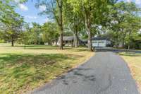 A lengthy single driveway provides ample parking space for all