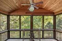 The screened deck off of the finished space above the garage has amazing privacy and wonderful views of the mature trees