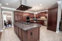 Beautiful stainless hood over the 6 burner gas cooktop