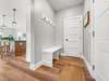 Mudroom at garage entry with coat closet/storage