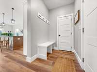 Mudroom at garage entry with coat closet/storage