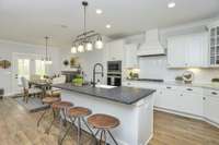 Gorgeous open Kitchen with loads of cabinets and large Island. Kitchen is open to Casual Dining Space and Great Room. Photo is of a similar floor plan, not actual home.