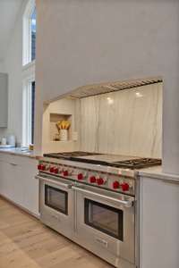 Double Wolf ovens, gas stovetops, and an extra large griddle all make cooking fun!