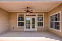 Sixteen foot patio space with a ceiling fan.  This space has an option to screen it in.