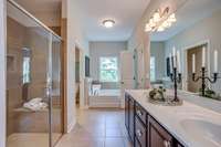 Double vanities, large tile walk-in shower.