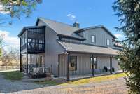 Upstairs screened in porch with the most incredible rolling pasture views