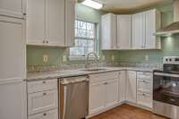 BEAUTIFUL KITCHEN WITH BRAND NEW GRANITE COUNTERS, CABINETRY AND APPLIANCES.