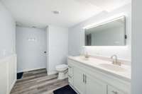 A full bathroom with double vanity sinks.