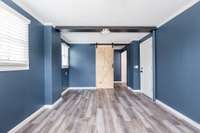 The primary bedroom, custom painted in calming blue, also features a walk in closet and new flooring.