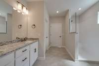 Primary bathroom with dual vanities and optional large walk-in shower Previously built home, actual finishes may vary