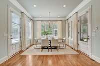 Breakfast nook with access to backyard and screened-in patio.