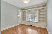 Third guest bedroom on main floor with built-in shelves and cute window seat.