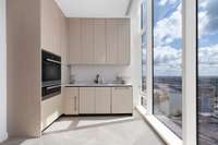 The catering kitchen features an oven, a warming drawer, an ice maker, sink, dishwasher, and a pantry.