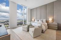 The primary bedroom is exquisitely furnished and has incredible views of the river and the lights of Broadway.