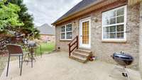 A private back patio off the kitchen provides space for grilling and outdoor entertaining.