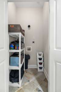 Closet is tiled and plumbed to be used as a second laundry room