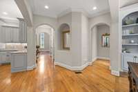 The hallway to the left leads to the foyer, the hallway to the right leads into the primary bedroom suite.