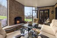 Screened-in patio with wood burning fireplace.