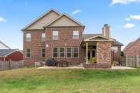 Back view of the all brick and stone home