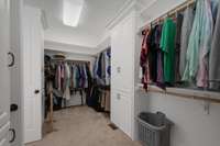 His and her sides in the walk-in closet with double storage on both ends